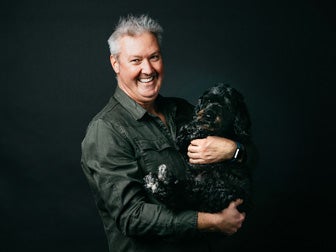 Man holding dog in his arms