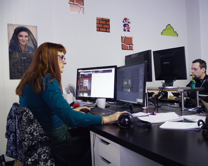 Woman working at a computer with two screens